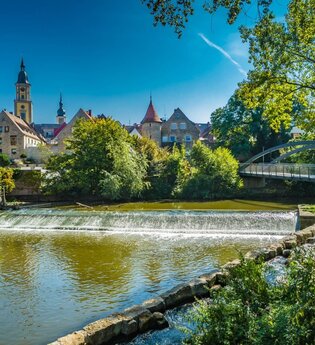 Zu sehen ist ein Fluss der durch eine Brücke führt